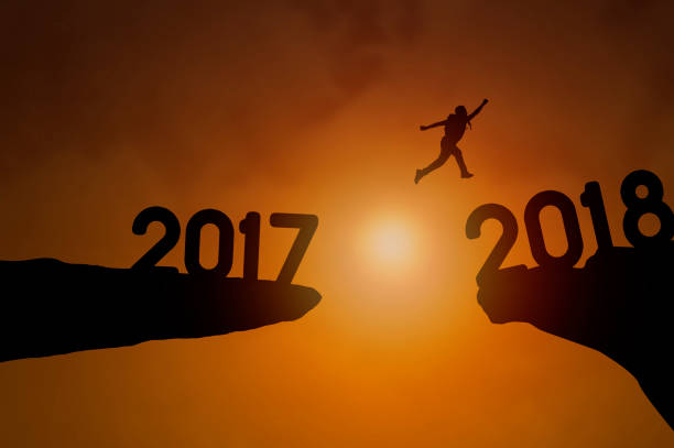 istock Silhouette people jumping on cliff to 2018, concept as happy new year background 838245010