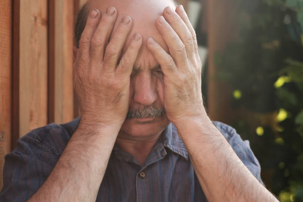 istock Mature man closing face with hands because of terrible headache or he forgot something 838245466
