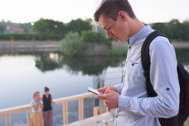 istock Side view of young caucasian man concerned about his smartphone 838245554