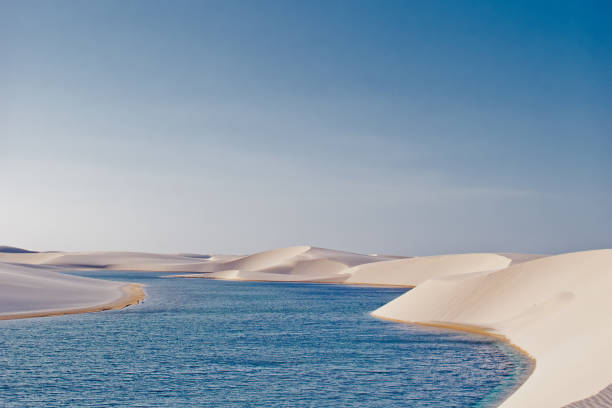 istock Peaceful lagoon of blue water between white sand dunes 838249840
