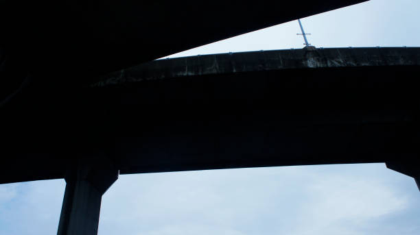 istock High contrast silhouette of highway ramps on a sunny day, useful for construction, engineering, transportation, building, industrial concepts 838252892