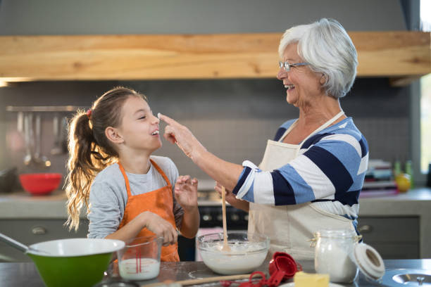 istock Grandmother putting flour on granddaughters nose 838252896