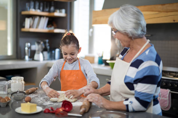 istock Granddaughter kneading dough 838253408