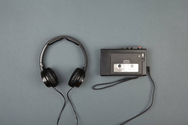 istock Retro cassette player with headphones on grey background 838263074
