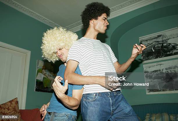 Two Men Playing Air Guitar Stock Photo - Download Image Now - Friendship, Humor, Dancing