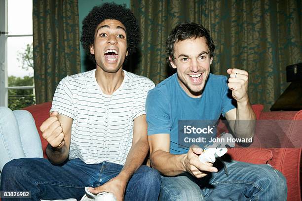 Friends Playing Video Game Stock Photo - Download Image Now - Video Game, Friendship, Gamer