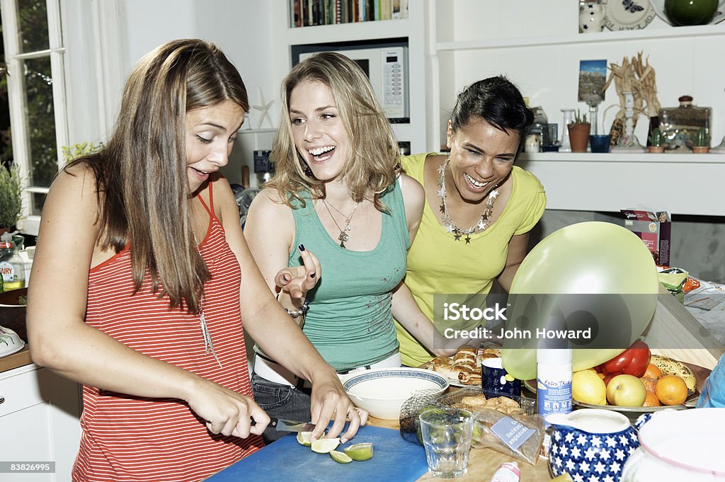 Three friends preparing food for party  Party - Social Event Stock Photo