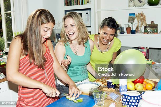 Three Friends Preparing Food For Party Stock Photo - Download Image Now - Party - Social Event, Cooking, Friendship