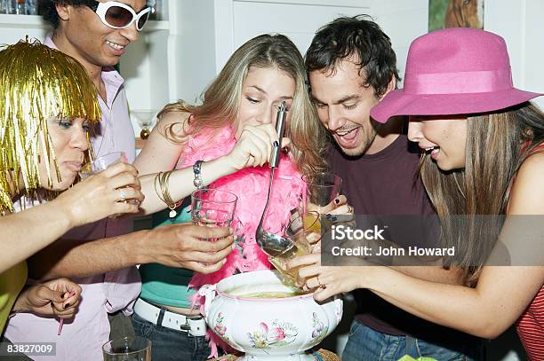 Friends Pouring Punch Into Glasses Stock Photo - Download Image Now - 20-24 Years, 25-29 Years, Adults Only