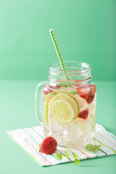 refreshing summer lemonade with strawberry and lime in mason jar refreshing summer lemonade with strawberry and lime in mason jar mason jar lemonade stock pictures, royalty-free photos & images