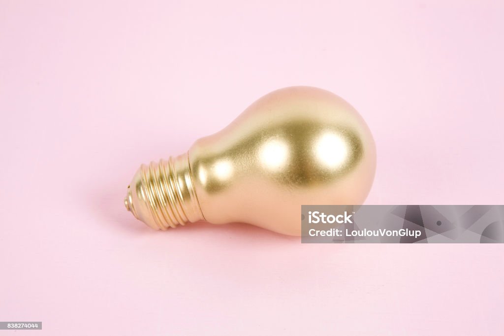 gold light bulb a light bulb painted in gold. Minimal color still life and quirky photography. Minimal color still life and quirky photography Cut Out Stock Photo