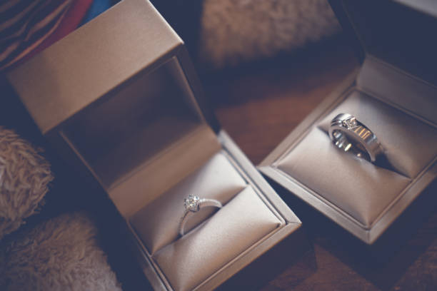 istock Two engagement ring in box on wood table 838277830