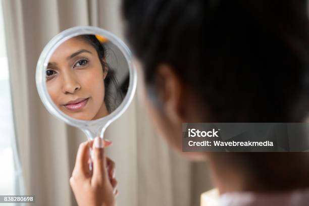 Woman Reflecting On Hand Mirror Stock Photo - Download Image Now - Mirror - Object, Looking, Women
