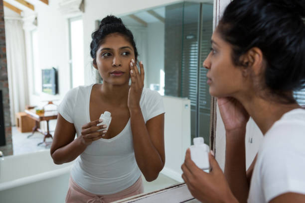 istock Young woman applying lotion 838282218