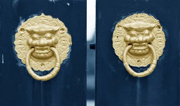 Photo of Traditional Chinese ancient architecture door red door and golden lion.