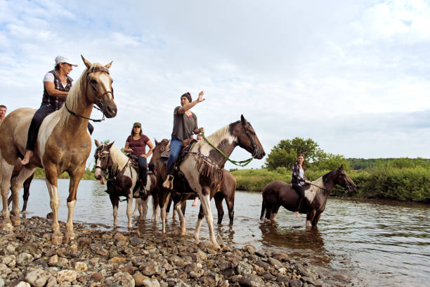 A group of people riding horses in Sardinia, Italy.