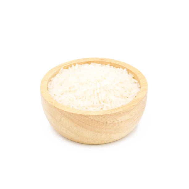 istock Rice in a wooden cup isolated on white background 838288630