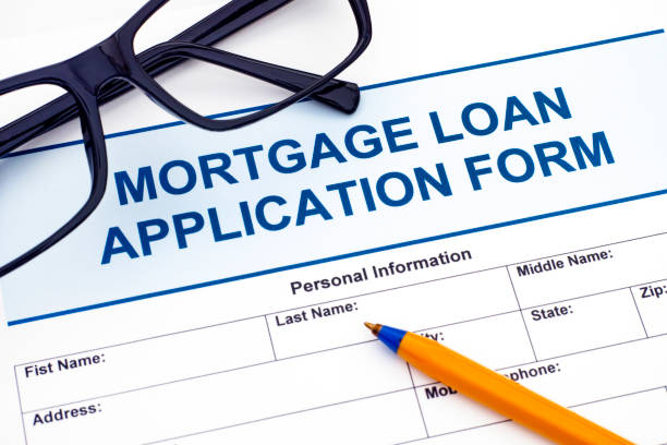 istock Mortgage Loan application form with ballpoint pen and glasses 838289710