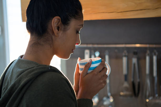 istock Woman having coffee in kitchen 838308618