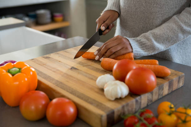 istock Mid section of woman cutting carrot 838310474
