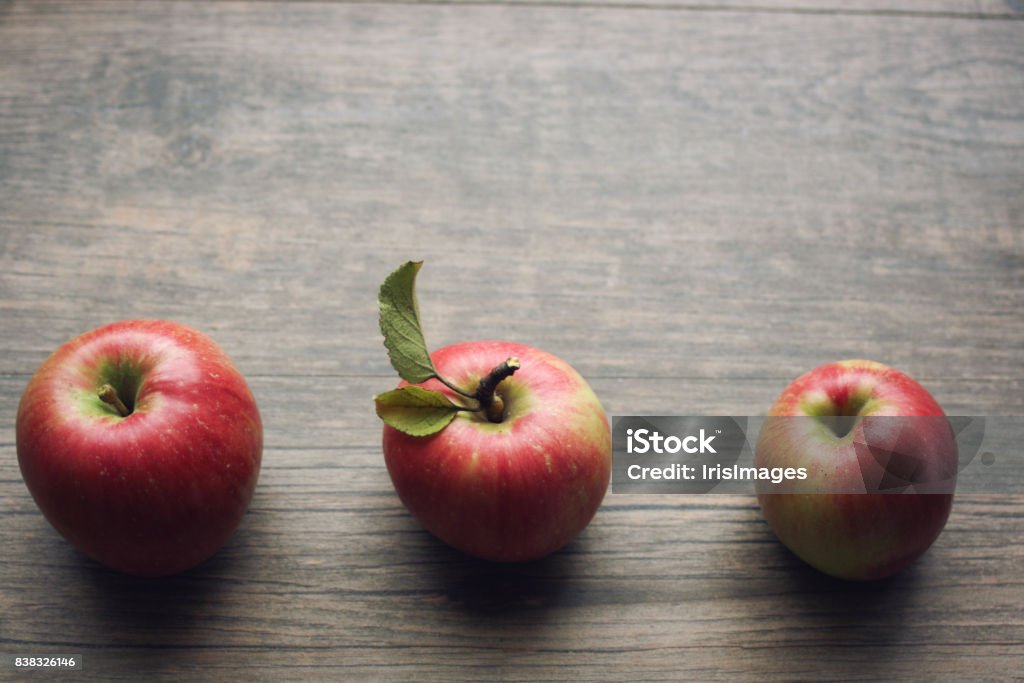 Autumn season still life with apples over rustic wooden background Autumn season still life with three apples over rustic wooden background. Copy space, horizontal. Apple - Fruit Stock Photo