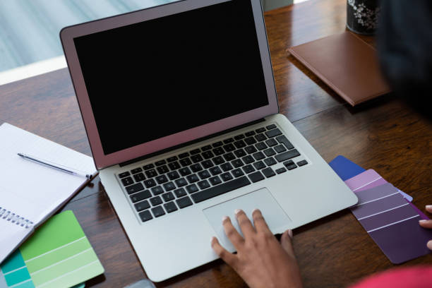 istock Cropped hand of woman using laptop 838330976