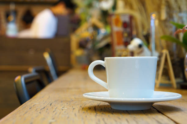 istock side view of espresso coffee in white cup on wooden table with blurred cafe background. copy space for text. 838337688