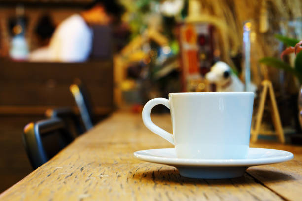 istock side view of espresso coffee in white cup on wooden table with blurred cafe background. copy space for text. 838337726