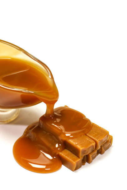 istock Caramel candies and sauce on white background 838342588