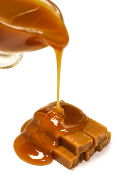 istock Caramel candies and sauce on white background 838342608