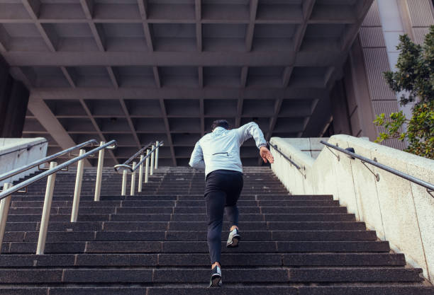 istock Back view of man running up the stairs 838343742