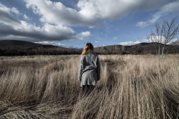 istock Woman posing in dried mountains field 838343822