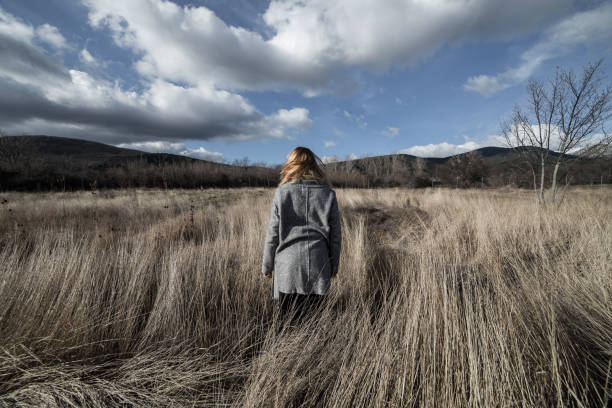 istock Woman posing in dried mountains field 838343972