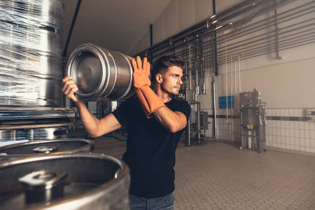 istock Brewer with large metal container at brewery 838349354