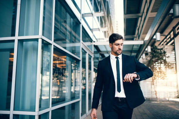 istock Young businessman looking at his watch while walking at airport 838349618
