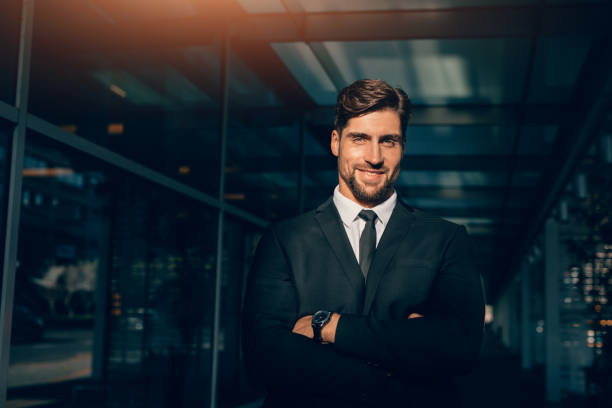 istock Smiling young businessman standing with his arms crossed 838349718