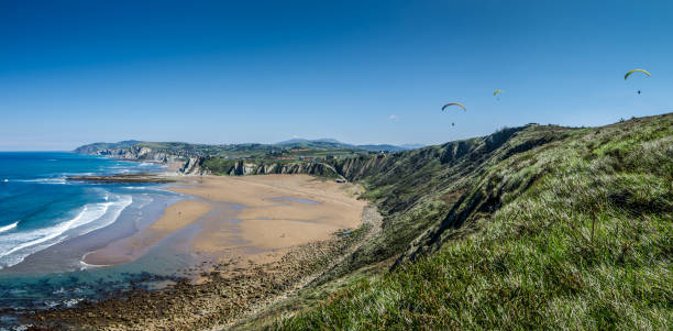 Paragliding over the beach in Sopelana Paragliding over the beach in Sopelana, Basque Country sopelana stock pictures, royalty-free photos & images