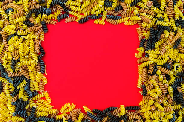 istock Uncooked pasta fusilli in different colours with copy space 838366998