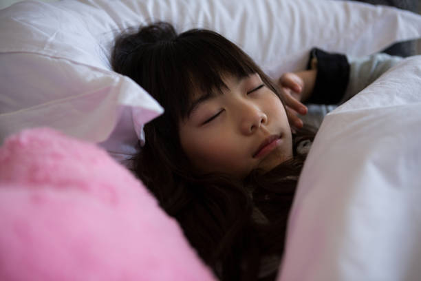 istock Girl with toy sleeping on bed 838371734