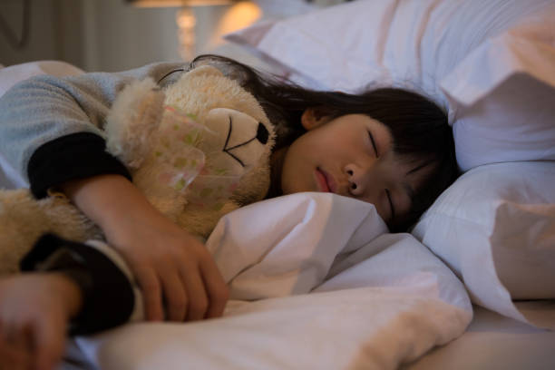 istock Girl with toy sleeping on bed at home 838371750
