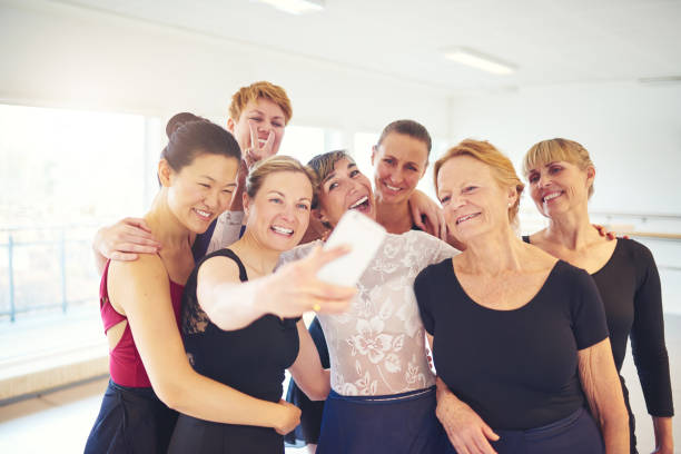 istock Group of smiling women taking selfies in a dance studio 838376054