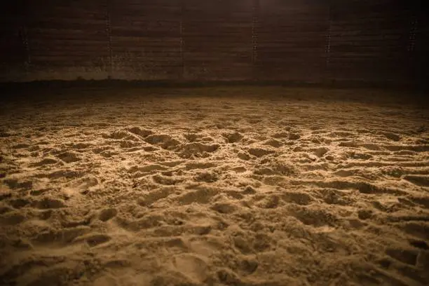 Sandy Horse Riding Arena with Light Spot in the Middle. Rodeo Photo Background.