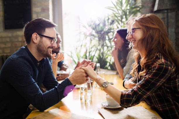 istock Handsome man flirting with cute woman in restaurant 838376546