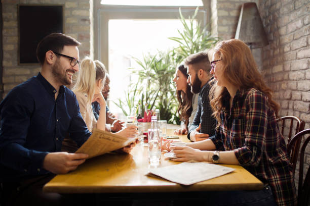 istock Happy colleagues from work socializing in restaurant 838376630