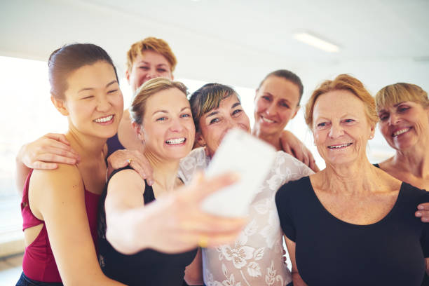 istock Group of smiling friends taking selfies in a dance studio 838379126
