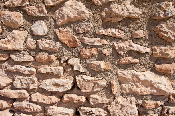 istock Stone wall, background texture pattern, old masonry, sandstone, southern architecture in the Caribbean style 838379394