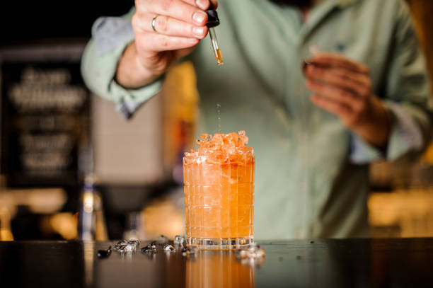 istock Bartender adds bitter to summer cocktail 838386190