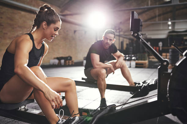 istock Two sportsmen preparing to workout rowing machines 838386238