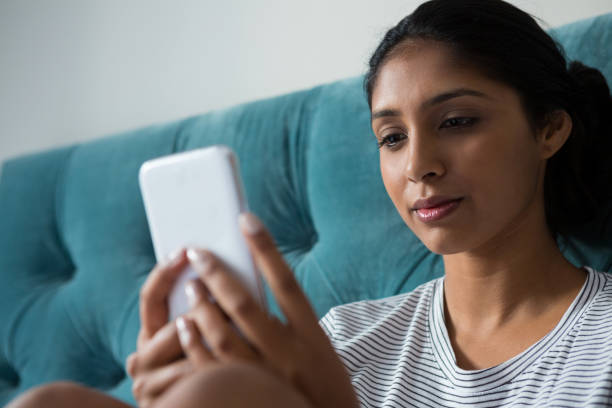 istock Young woman using phone at home 838386464