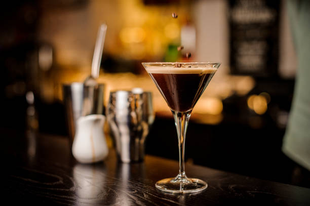 classy bartender garnish martini espresso cocktail drink foam coffee bean on top bar counter